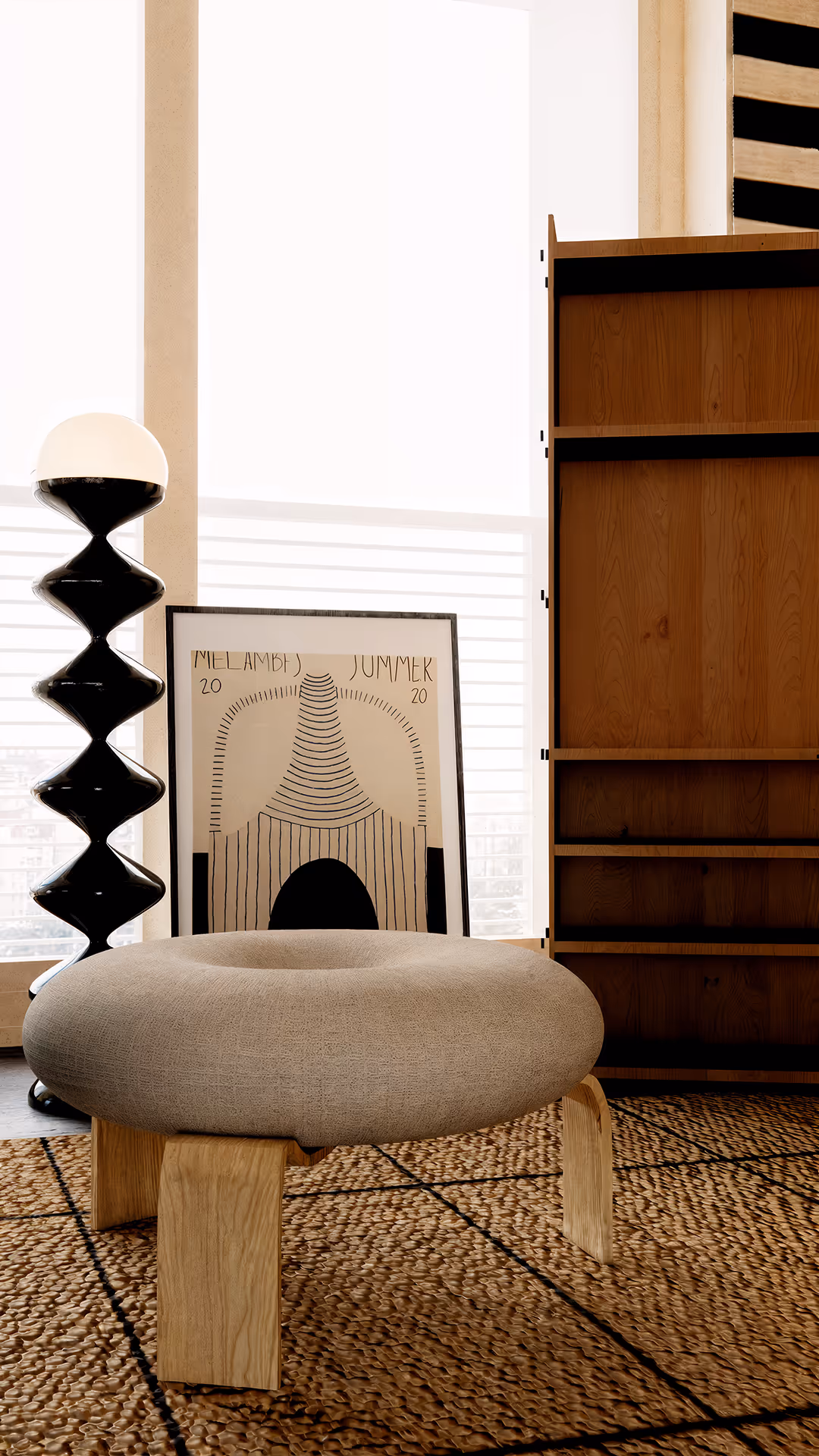Building on a foundation of luxurious black and wood, the space is thoughtfully composed with textured furniture and finishes, creating a clean yet deeply layered atmosphere. The wood, in particular, adds warmth and a natural rhythm throughout the space, appearing in various forms—from accent wall panels and rich-toned flooring to detailed elements in select furniture pieces—enhancing the overall sense of cohesion.