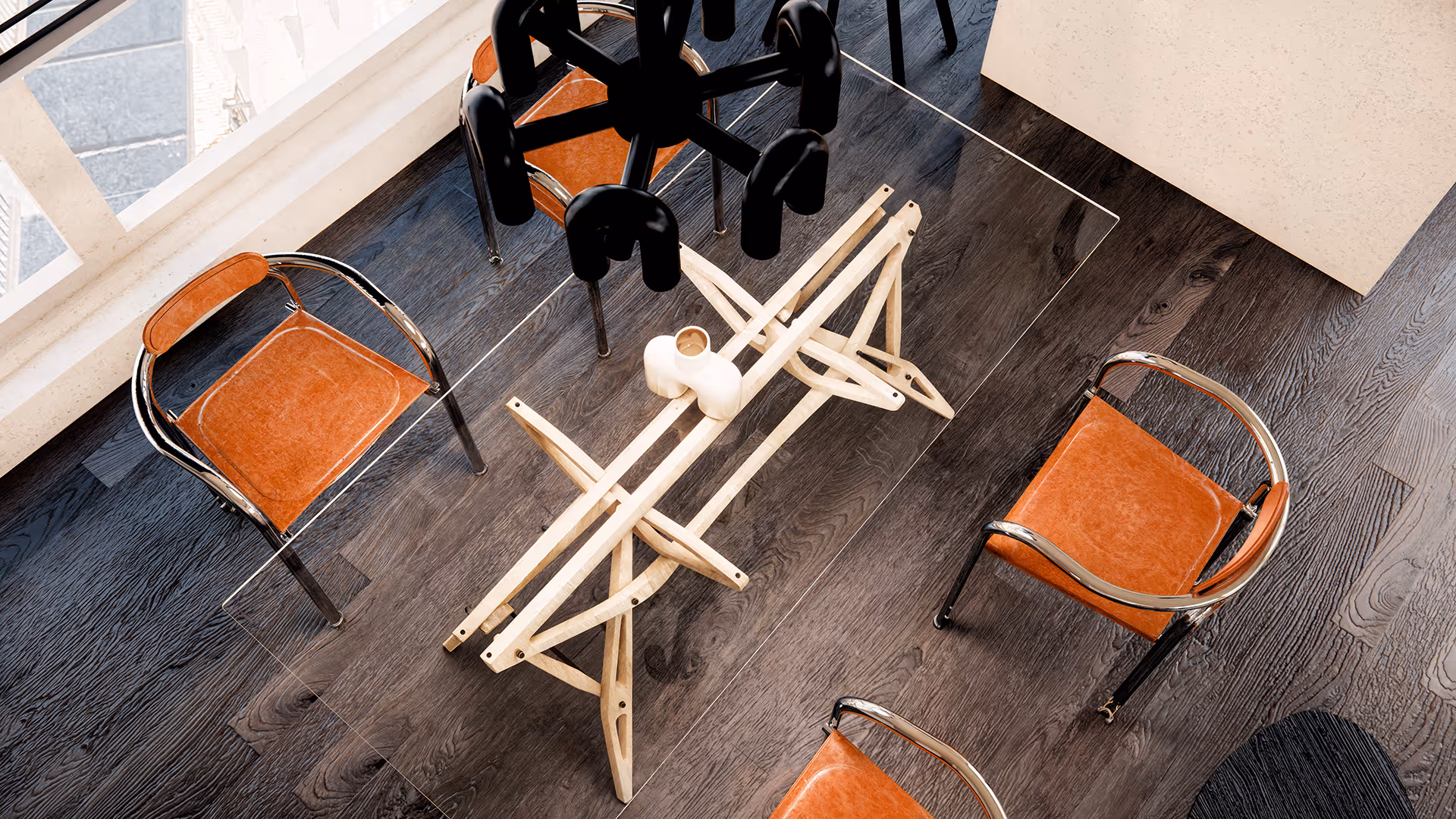 The space is designed without functional separation, allowing dining, work, and seating areas to blend and interact freely. Instead of using partitions or walls, the zones are subtly defined through the arrangement of furniture and contrasts in materials, creating a natural division that maintains an open and fluid flow throughout the space.