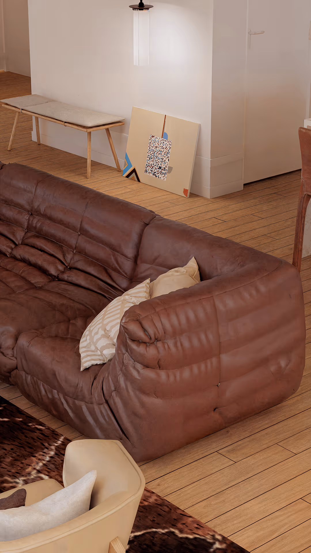 A leather sofa offers a refined blend of luxury and durability, enhancing the space with its deep texture and timeless appeal. Its breathable and supportive material ensures long-lasting comfort, while the rich brown tone anchors the room with visual warmth and sophistication.