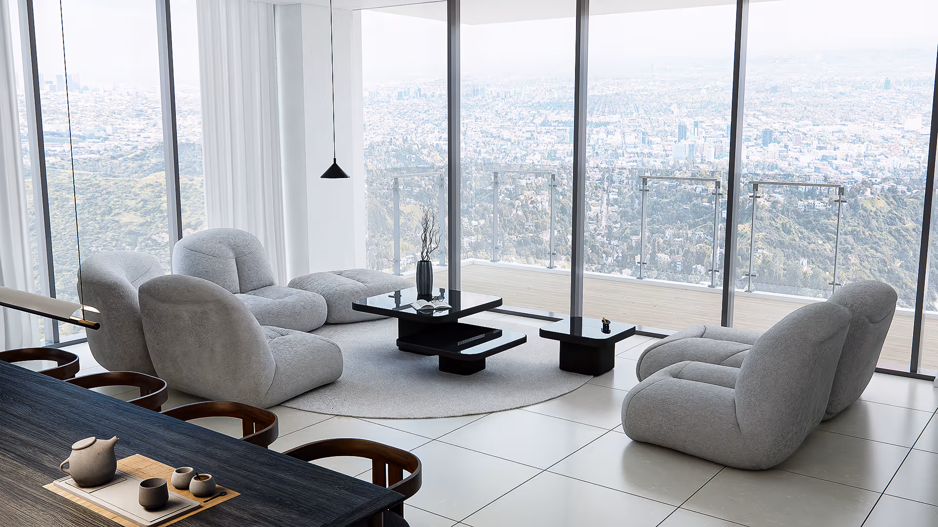 Anchored by plush, low-slung seating, this living room opens fully to the city beyond. The expansive windows dissolve the boundary between inside and out, while the gentle curve of the sofas invites quiet moments of reflection. Black gloss tables float in the center like sculptural planes, offering both contrast and composure.