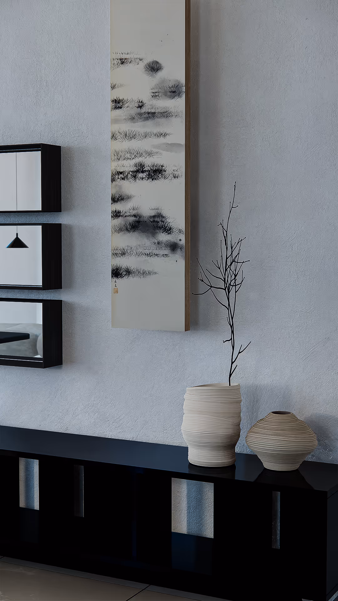 A moment of stillness is captured in this minimalist vignette. An abstract ink painting evokes the essence of nature through delicate brushwork, while the sculptural ceramics beneath it echo the quiet elegance of wabi-sabi philosophy. The empty space between each object becomes just as meaningful as the objects themselves—an intentional pause within the flow of the room.