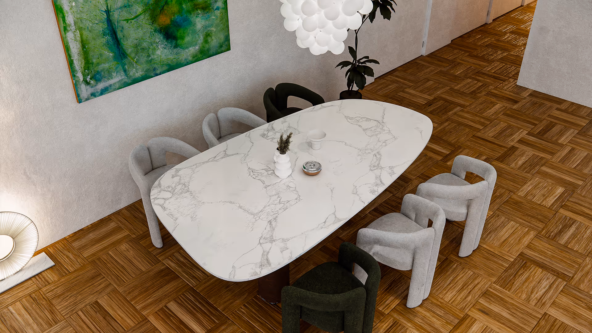 From above, the asymmetrical layout becomes apparent—chairs in alternating colors are placed around an elongated oval table, offering both visual rhythm and balance. The marble’s soft grey veining flows gently like a natural pattern, unifying the composition without overwhelming it.